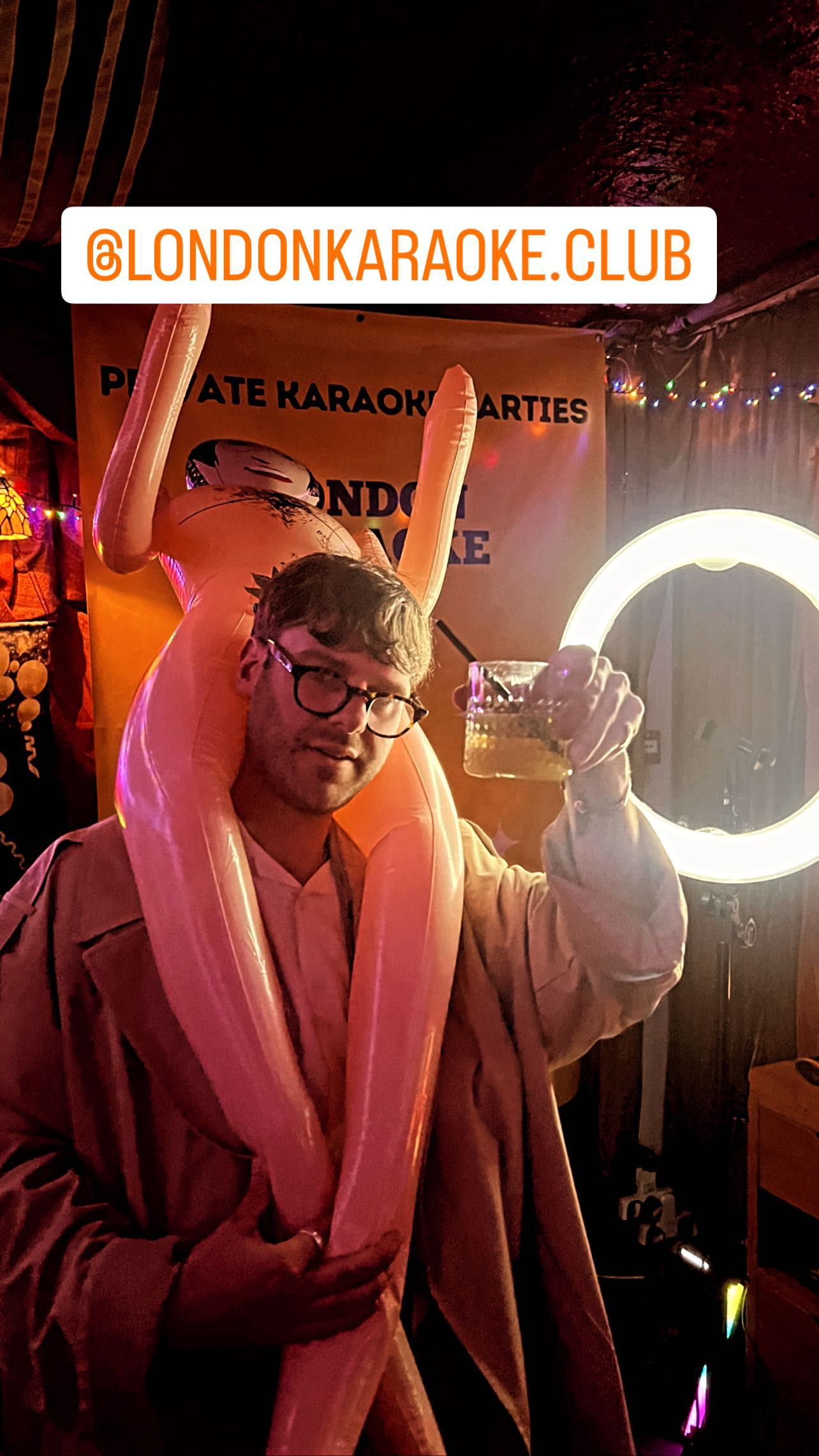 Work party karaoke guest celebrating beneath a disco ball